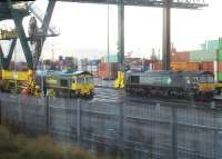 Freightliner locomotives 66534 and 66418 (the latter still in former operator DRS livery) under a large container straddle crane at Birmingham Lawley Street Freightliner Terminal on the morning of 3 December 2012.<br><br>[David Pesterfield 03/12/2012]