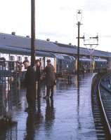 Triple-headed Type 2s wait to head south from a wet Inverness Platform 4 in the early 1970s. Frank Spaven and his youngest son are to the right of the lighting column. The train is thought to be the 08.20 service to Edinburgh.<br><br>[David Spaven //]