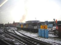 Devon & Cornwall Railway Company's 56311, coupled to ex Jarvis Rail 56301 in sidings alongside Derby Station south junction, emits an initial burst of 'clag' just after being started up on a cold and frosty 15 January morning. <br><br>[David Pesterfield 15/01/2013]
