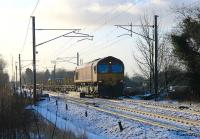 Early DBS/EWS Class 66 No. 66003, now in its 15th year of service, heads an infrastructure train north on the WCML at Brock. The early sun was already thawing the overnight snow as this train followed the preceding steam special.<br><br>[Mark Bartlett 26/01/2013]