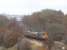 The West and South Yorkshire section of the Network Rail RHTT operation sees 20303 leading the set towards Barnsley on 14 November with 20312 at the rear. The train is passing the site of Crigglestone Junction signalbox which stood to the left of the line here. A section of the Midland Railway viaduct at Calder Grove on the Thornhill to Notton branch can be seen through the gap in the trees. [See image 28049] for a similar view almost 40 years earlier.<br><br>[David Pesterfield 14/11/2012]