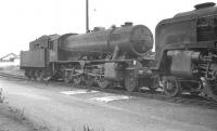 WD 'Austerity' 2-8-0 no 90299 stabled in the shed yard at Southall (81C) in the summer of 1961. The locomotive is standing face-to-face with BR Standard class 9F 2-10-0 no 92214 [see image 33519].<br><br>[K A Gray 20/08/1961]