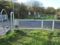 View along the trackbed at Hill Side Lane Level Crossing, Millhouse Green, west of Penistone in November 2012, showing the north side rail of both tracks still in position across the road. This section of the former Manchester to Wath 1500V DC electrified line is now part of the Trans Pennine Trail.<br><br>[David Pesterfield 11/11/2012]