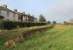 After a short and unprofitable life, famously served by a horse drawn tram for much of its existence, the Port Carlisle branch closed completely in 1932. However, over 80 years later the station platform can still be seen. This view looks towards the buffers but the final stretch of trackbed has been infilled to make a car park for the Port Carlisle Bowling Club, albeit with the platform edging stones still visible. <br><br>[Mark Bartlett 03/02/2013]