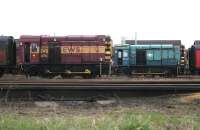 A pair of class 08 shunters in the north sidings at Motherwell shed in February 2006, with 08402 in EWS livery and 08927 in BR colours. No 08402 (formerly D3517) was eventually cut up at T J Thomson, Stockton, in March 2010, while  08927, built at Horwich in 1962 as D4157, had better luck and is now preserved at NRM Shildon. [See image 40691]. <br><br>[John Furnevel 25/02/2006]