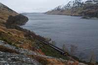 A northbound Sprinter is just about to enter Loch Treig Tunnel on the deviation. The deviation begins close to the bend in the line in the background with the original line now flooded when the reservoir is full. In the background right are the valve shafts for the pipeline to the Locaber Smelter, that location being the eastern terminus of the Lochaber Narrow Gauge Railway.<br><br>[Ewan Crawford 11/02/2013]