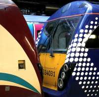 Contrasting colour schemes at Waverley on 24 February. A pair of ScotRail 334 units with a TransPennine 185 behind.<br><br>[Bill Roberton 24/02/2013]