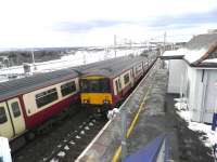 Trains to and from Lanark passing at a snowy Carluke station on 12 March 2013.<br><br>[John Yellowlees 12/03/2013]