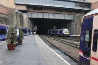 The station throat at Glasgow Queen St and a Class 170 is seen entering the tunnel on a service for Edinburgh. On the left another Class 170 waits to form a departure for Alloa while on the right 158718 will follow the Edinburgh train up the bank but then turn right at Eastfield for Falkirk Grahamston via Cumbernauld. <br><br>[Mark Bartlett 08/03/2013]