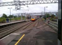 A down Pendolino about to pass Nuneaton platform 3 at full line speed. The damaged up end of the platform is clearly visible 38 years on from the crash [see image 41807].<br><br>[Ken Strachan 13/07/2012]