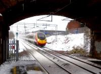 A Pendolino (destination unknown) heading East, about to pass through Adderley Park station at speed on 24 March. Notice the icicles hanging from the road bridge.<br><br>[Ken Strachan 24/03/2013]