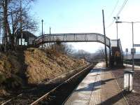 The unusual curved split-level footbridge at Rannoch Station, seen looking south during a station stop on 19 February 2013.<br><br>[David Pesterfield 19/02/2013]