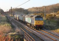 A fine spring evening at last. The former Freightliner Class 57s are now regulars on DRS nuclear flask traffic and 57003+57007 are seen here heading south at Woodacre with a Sellafield to Crewe train. These locos emerged from the Brush works at Loughborough in early 1965 as D1798 and D1813, later becoming 47317 and 47332.<br><br>[Mark Bartlett 16/04/2013]
