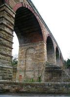 The northern end of Newbattle Viaduct on the Waverley route, looking south towards Newtongrange on 12 April 2013. This is the point where the 23-arch structure spans the South Esk, running just beyond the wall in the foreground. [See image 33036]<br><br>[John Furnevel 12/04/2013]