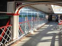 The footbridge at Chester has undergone recent improvement with a copper finish skirting and low level tubing installed along each side. The over track section has also had glazing erected on both sides as wind protection.<br><br>[David Pesterfield 16/04/2013]