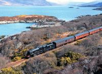 Friday the 26th of April brought heavy frequent showers of sleet and rain to the Highlands. Here the sun makes a rare appearance as Black 5 no 45407 hauls the <I>Great Britain VI</I> west of Duirinish on the way to Kyle of Lochalsh, with Loch Kishorn in the background. <br><br>[John Gray 26/04/2013]