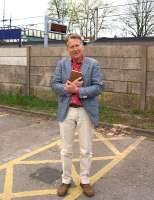 With Bradshaw in hand whilst filming in the North-West, Michael Portillo stands at Leyland on a rather dull Friday evening. The film crew had packed up and were about to move off when he kindly agreed to pose for one more photo after a long day on the road. He told me that he was making a programme on the railways around Manchester. <br>
<br><br>[John McIntyre 04/05/2013]