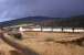 Stormy skies over Kielder in April 1964. Virtually the same location as the photograph taken 14 years earlier [see image 27306] although the rails have long gone and a terrace of new Forestry Commission houses has appeared.<br><br>[Frank Spaven Collection (Courtesy David Spaven) /04/1964]