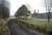 Remains of Knock station, Banffshire, looking north towards Tillynaught in 1997, some 29 years after closure of the line. The Knockdhu distillery stands on the right. Note the posts that once carried the station nameboard hiding amongst the trees. <br><br>[Ewan Crawford //1997]