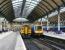 Passengers wait to board a Bridlington train at Hull platform 7 in April 2009. Standing alongside at platform 6 is a recently arrived service from Manchester Piccadilly.<br><br>[John Furnevel 23/04/2009]