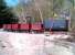 A rake of wagons at Coleford on the Perrygrove Railway in March 2013. The broom leaning on the wagon on the right shows us how small these wagons are. It's the biggest of the six - and the broom isn't exactly vertical. Try that on an HAA.<br><br>[Ken Strachan 31/03/2013]