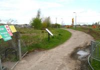 The closed walkway at Hardengreen on 10 May 2013. View north, with work taking place towards what will become the site of the new Eskbank station, once the filled-in cutting has been re-excavated. The Tesco Hardengreen Superstore is in the left background.<br><br>[John Furnevel 10/05/2013]