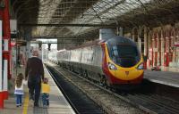 A Birmingham bound Pendolino leaving platform 4 at Preston on 23 April 2013 as two young enthusiasts head away having been shown the pair of Black 5s on the <i>Great Britain VI</i> railtour out of the shot to the left.<br><br>[John McIntyre 23/04/2013]