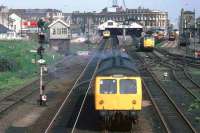 A full house at Lowestoft on 16th May 1981, with a Norwich service departing, an Ipswich service boarding and Class 31 and 08 locos in the sidings. The sadly missed overall roof lasted until 1992 [see image 43037]. Platform 1 (far left) fell into disuse after the line to Yarmouth South Town closed in 1970.<br><br>[Mark Dufton 16/05/1981]