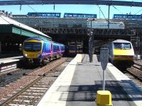 TransPennine Express 185122 departs Waverley west end platform 13 on the 12.11 service to Manchester Airport via Carlisle as 91002 rests at platform 11 after arrival some 5 minutes earlier on the 07.30 ex Kings Cross East Coast service. <br><br>[David Pesterfield 04/06/2013]