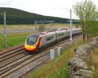 A northbound Pendolino passes Beattock Summit and the road traffic on the M74 behind it (in more ways than one!) on 03 June 2013.<br><br>[John McIntyre 03/06/2013]
