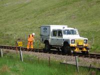 A Network Rail track team with rail mounted Land Rover standing by milepost 43 south of Bridge of Orchy on 26 June 2013. They had approximately 15 minutes left to clear the section by 13.00 for the ex Mallaig service to pass through.<br><br>[David Pesterfield 26/06/2013]