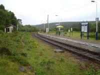 View north at Kildonan Station in June 2013 showing the current up and former down platform. Note the contrasting styles of the old and new waiting shelters.<br><br>[David Pesterfield 23/06/2013]