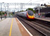 A down Pendolino rushes through Bletchley on a hot Monday evening in July 2013.<br><br>[Ken Strachan 15/07/2013]
