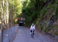 A below-average number of cyclists enjoying smooth new tarmac as they leave the south portal (near Midford) of Combe Down tunnel, which is internally lit from 5am to 11pm; and offers music while you ride. [See image 35576]<br><br>[Ken Strachan 07/07/2013]