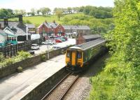 The 11.44 Northern service to Whitby arrives at Grosmont platform 1 off the Esk Valley line on a hot and humid 6 June. The train has approximately 20 minutes remaining of its journey from Middlesbrough. Platforms 2-4, which handle NYMR services, are off to the left.<br><br>[John Furnevel 06/06/2013]
