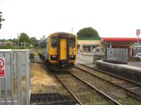 Arriva Trains Wales single car unit 153353 runs north over the level crossing on departure from Llandovery on 16 July as it heads back to Shrewsbury with the 09.15 ex Swansea <I>Heart of Wales Line</I> service.<br><br>[David Pesterfield 16/07/2013]