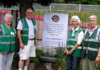 Volunteers at Milngavie station alongside the <I>Milngavie in Bloom</I> poster currently on display there. A small exhibition to commemorate the 150th Anniversary of Milngavie station is to be held in the nearby Town Hall from 10th-14th September alongside displays showing the work of some of the Milngavie clubs and societies during that period. It will also be part of East Dunbartonshire Doors Open Day on 14th September.<br><br>[John Yellowlees 27/07/2013]