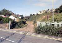 Level crossing remains at Instow in 1990 looking towards Barnstaple. The former Instow station, closed to passengers in 1965, stands on the other side of Marine Parade behind the camera. The line closed completely in 1982 and the trackbed is now part of <I>The Tarka Trail</I>.<br><br>[Ian Dinmore //1990]