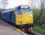 A train stands at the platform at Oakworth on 27 April 2013. On the front is preserved diesel locomotive 25059.<br><br>[Colin Alexander 27/04/2013]