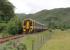 Kyle of Lochalsh bound 158707 heads away from the camera after calling at Attadale Halt with an afternoon service from Inverness in July 2012. Taken from the north (sea loch) side, with the A890 road on the other side of the line. <br><br>[Mark Bartlett 11/07/2012]