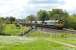 Empties from Fiddlers Ferry to Hunterston pass through the closed station at Bay Horse on 24 May behind Freightliner 66520. The station house, now a private residence, can be seen on the left of the picture, although the platforms were cut back many years ago. <br><br>[Mark Bartlett 24/05/2013]