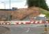 Preparing the way for the new Borders Railway bridge over Hardengreen roundabout on 25 June 2013. View west showing preparatory work in progress on the south side of the roundabout. The tipper truck has reached its position at the top of the embankment via Newbattle Viaduct [see image 33036] and the old Waverley trackbed, a route currently being used by construction traffic as an alternative to the A7... much to the relief of drivers on the A7.<br><br>[John Furnevel 25/06/2013]