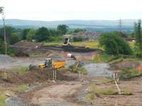 View south west at Hardengreen on 25 June with the new Eskbank station behind the camera. Hardengreen roundabout is out of sight below trackbed level in the centre of the picture. The tipping activity in the background is taking place on the south side of the roundabout and the red van is heading back towards Newbattle Viaduct. [See image 43557] <br><br>[John Furnevel 25/06/2013]