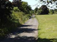 View west along the course of the Leven branch in July 2013, now the access road to the KFRPS's Methil site.<br><br>[Bill Roberton 06/07/2013]