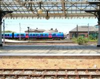 The 10.06 Manchester Airport - Newcastle Central pulls away from platform 11 at York on 4 June. View across the running lines from the east side car park. In the foreground is bay platform 2, which connects only with the Scarborough line and is normally used for stabling purposes.  <br><br>[John Furnevel 04/06/2013]