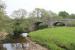 Just to the north of Tarset station is this splendid three arch skew bridge that once carried the Border Counties line over the Tarset Burn near the point where it joins the North Tyne. The bridge is being maintained in good order and the right hand arch has been lined with concrete. [See image 21691] for a view of the site of Tarset station itself. <br><br>[Mark Bartlett 07/06/2013]