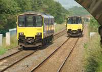 Looking east under the road bridge at Hapton station on 5 July as Northern Class 150 units pass on services running between Blackpool South and Colne.<br><br>[John McIntyre 05/07/2013]