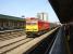 DBS 60063 heads west thro Cardiff Central on a roasting hot July afternoon with a lengthy rake of covered steel wagons returning from Dee Marsh to Margam Knuckle Yard.<br><br>[David Pesterfield 17/07/2013]