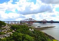 A view of the Forth Bridge taken from the Road Bridge on 30 July looking east over North Queensferry. A Turbostar is heading north into Fife.<br><br>[John Gray 30/07/2013]