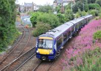 Northbound 170428 coasts downhill towards Inverkeithing station on 29 July 2013. Maintenance is being carried out in the background on the Rosyth Dockyard branch.<br><br>[Bill Roberton 29/07/2013]